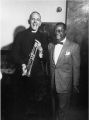 Louis Armstrong donating the trumpet to Father Trevor Huddleston.jpg